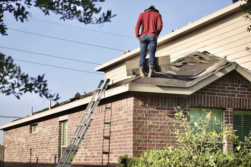 Professional roofer working on a residential roof in New Market View
